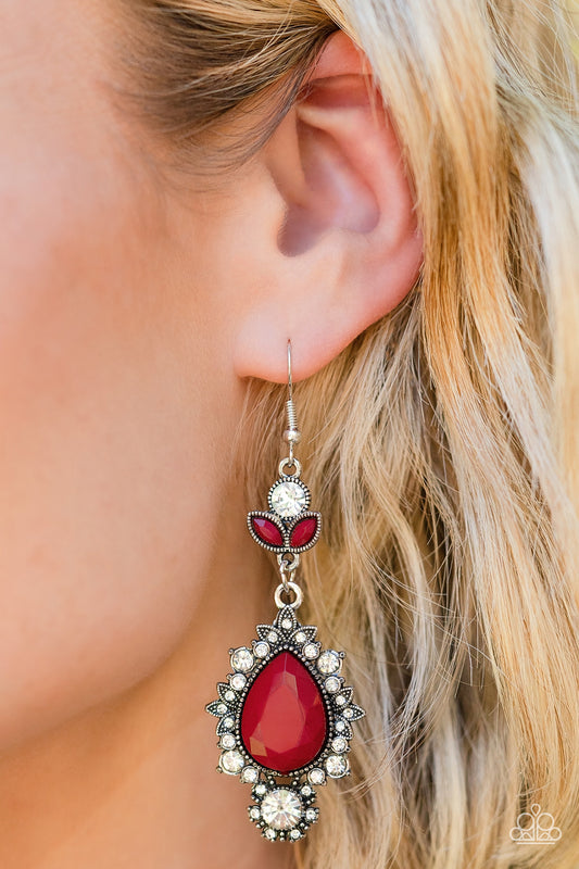 Dotted with dainty white rhinestones, leafy silver frames bloom from an oversized red teardrop bead that delicately hangs from a leafy white rhinestone and red beaded fitting for a whimsical finish. Earring attaches to a standard fishhook fitting.  Sold as one pair of earrings.