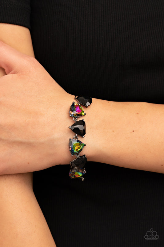 Triangular cut black beads and oil spill gems alternate around the wrist, creating a prismatic pop of color. Features an adjustable clasp closure.  Sold as one individual bracelet.