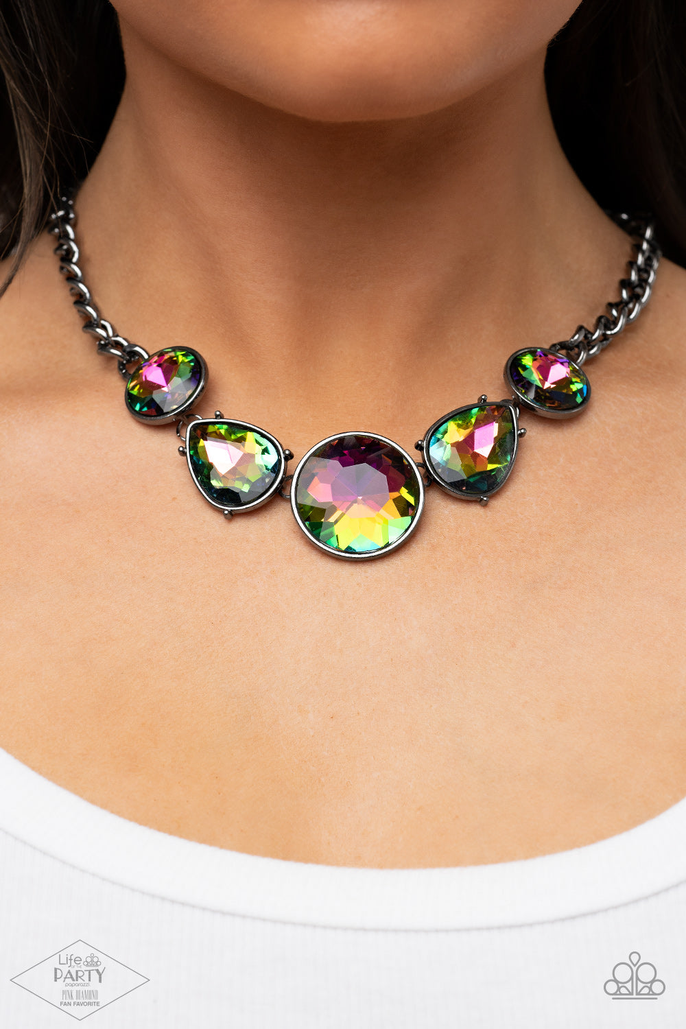 Infused with heavy gunmetal chain, an exaggerated display of round and teardrop-shaped oil spill rhinestones connects below the collar for a blinding look. Features an adjustable clasp closure.  Sold as one individual necklace. Includes one pair of matching earrings.