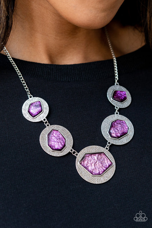 Featuring a refracted shimmer, asymmetrical, glassy purple gems sparkle atop textured silver discs as they delicately link into an edgy statement piece below the collar. Features an adjustable clasp closure.  Sold as one individual necklace. Includes one pair of matching earrings.