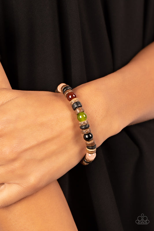 Glassy multicolored stone beads join trios of black and brown wooden discs along stretchy bands around the wrist, resulting in an earthy pop of color.  Sold as one individual bracelet.