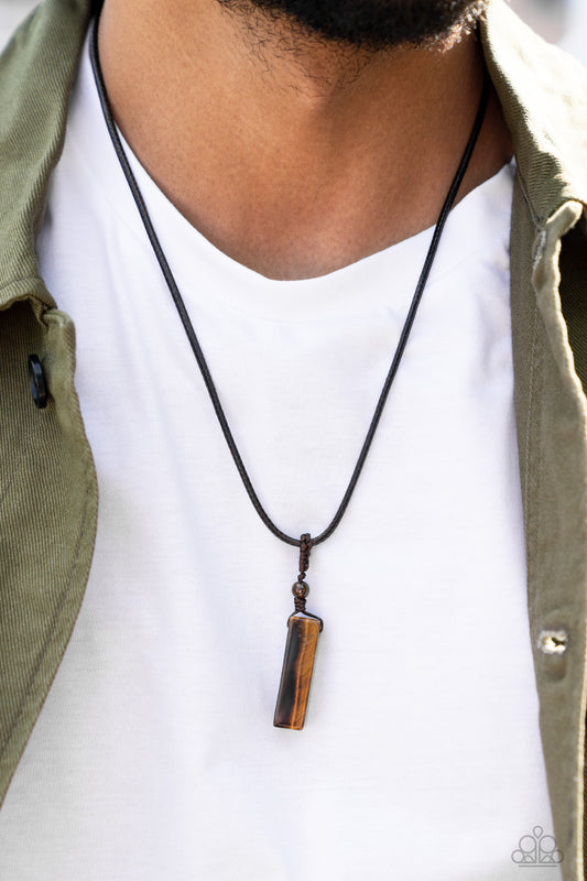 A rectangular tiger's eye stone pendulum is knotted in place below a dainty tiger's eye stone bead that glides along a shiny brown cord below the collar, resulting in an earthy pendant. Features an adjustable sliding knot closure.  Sold as one individual necklace.