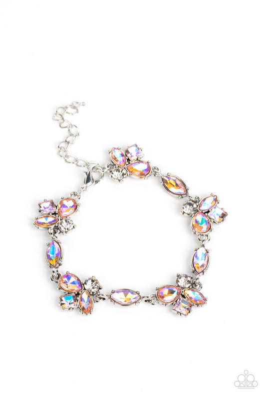 Featuring various cuts and finishes, dainty clusters of white, pink, and orange iridescent rhinestones delicately link with marquise cut rhinestones around the wrist for an effervescent elegance. Features an adjustable clasp closure.  Sold as one individual bracelet.