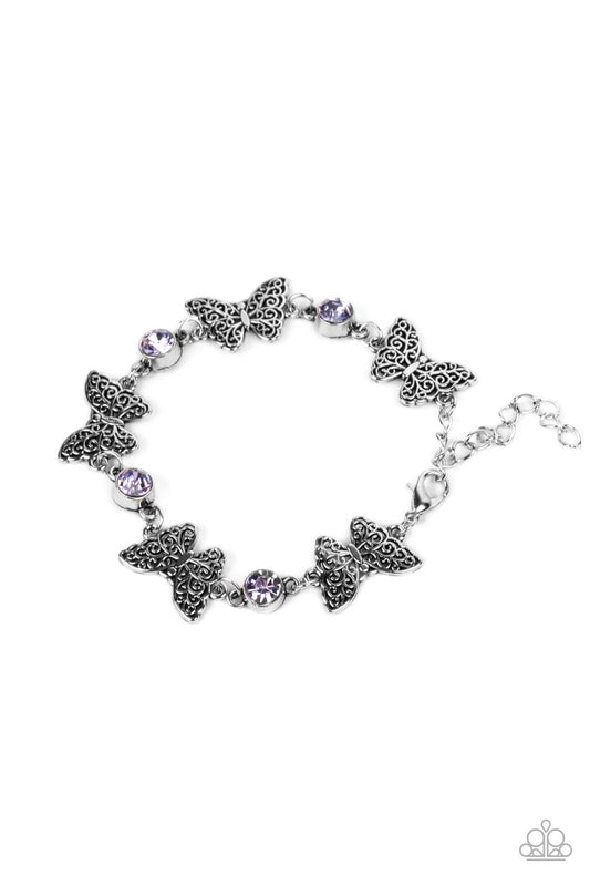 Featuring filigree filled wings, dainty silver butterflies alternate with Very Peri rhinestones around the wrist for a whimsical sparkle. Features an adjustable clasp closure.  Sold as one individual bracelet.