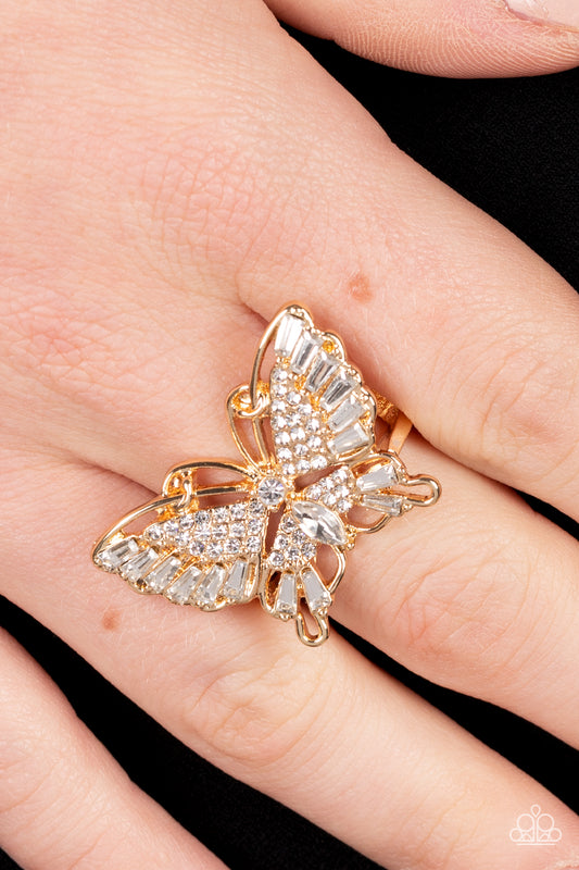 Sparkling with round, teardrop, and emerald cut white rhinestones, a gold butterfly fearlessly flutters atop the finger for a statement-making finish. Features a stretchy band for a flexible fit.  Sold as one individual ring.