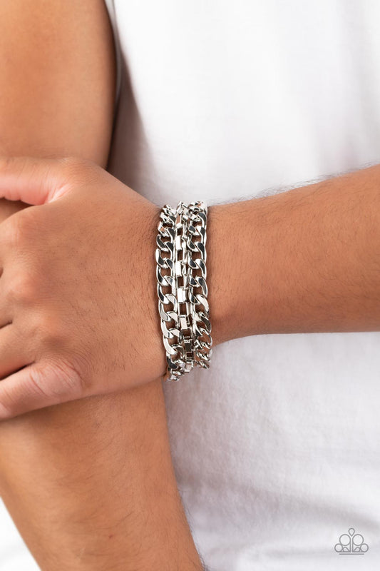 Glistening silver curb and box chains wrap around the wrist for a grungy, industrial look. Features an adjustable clasp closure.   Featured inside The Preview at GLOW! Sold as one individual bracelet.