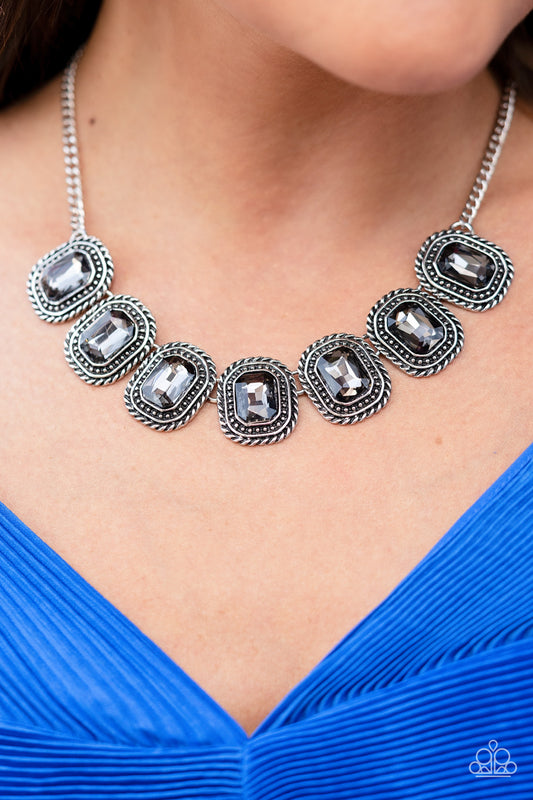 Pressed into silver, chain-like frames, radiant-cut hematite rhinestones smolder below the collar in a jaw-dropping finish. Features an adjustable clasp closure.  Sold as one individual necklace. Includes one pair of matching earrings.