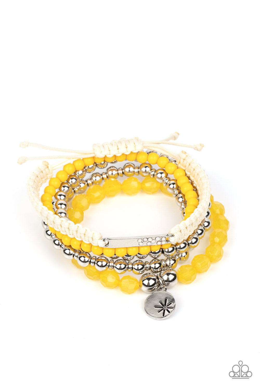 Strands of yellow beads in the vibrant Pantone® of Samoan Sun are threaded along stretchy elastic bands to create a stack of bracelets. The varying opacities of each yellow bead adds depth to the design, as a strand of silver beads adds metallic sheen. A silver disc stamped with a star offers a whimsical accent, as a silver bar dotted with opalescent rhinestones is tied to another bracelet created with ivory cording and a sliding knot closure.  Sold as one set of five bracelets.