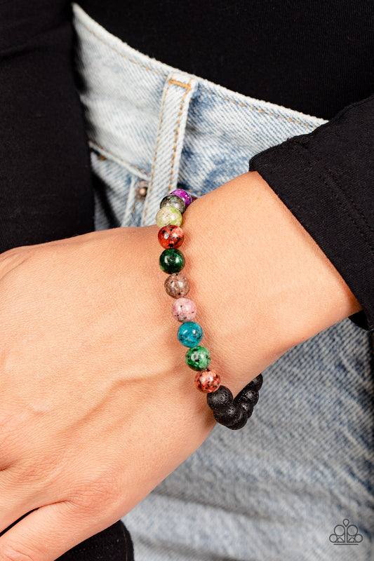 A collection of refreshing multicolored stone beads with speckled detailing, and earthy lava rock beads are threaded along a stretchy band around the wrist for an urban finish. As the stone elements in this piece are natural, some color variation is normal.  Sold as one individual bracelet.