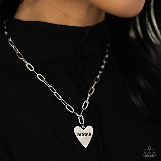 High-sheen silver ovals link down the chest drawing attention to the silver heart pendant at its bottom. Stamped with the word "mama" in its center, this monochromatic masterpiece gives off a simplistic, sentimental style. Features an adjustable clasp closure.  Sold as one individual necklace. Includes one pair of matching earrings.