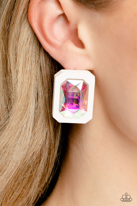 Standing out against a white rubber backdrop, an oversized, faceted emerald-cut iridescent gem shimmers and shines for an edgy sparkle against the ear. Earring attaches to a standard post fitting. Due to its prismatic palette, color may vary.  Sold as one pair of post earrings.