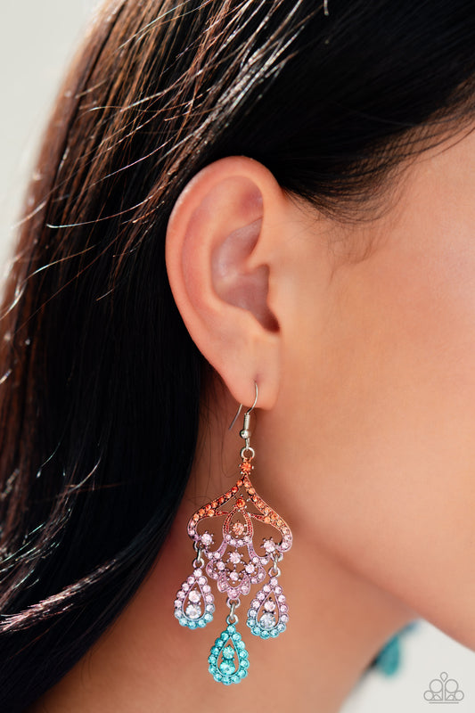 Three rhinestone-encrusted teardrops drip from the bottom of an ornate decorative frame, creating an elegant fringe. The decorative frame swirls with ombré rhinestones that go from orange to pink to blue shades in varying sizes for a timelessly over-the-top sparkle. Earring attaches to a standard fishhook fitting.  Sold as one pair of earrings.