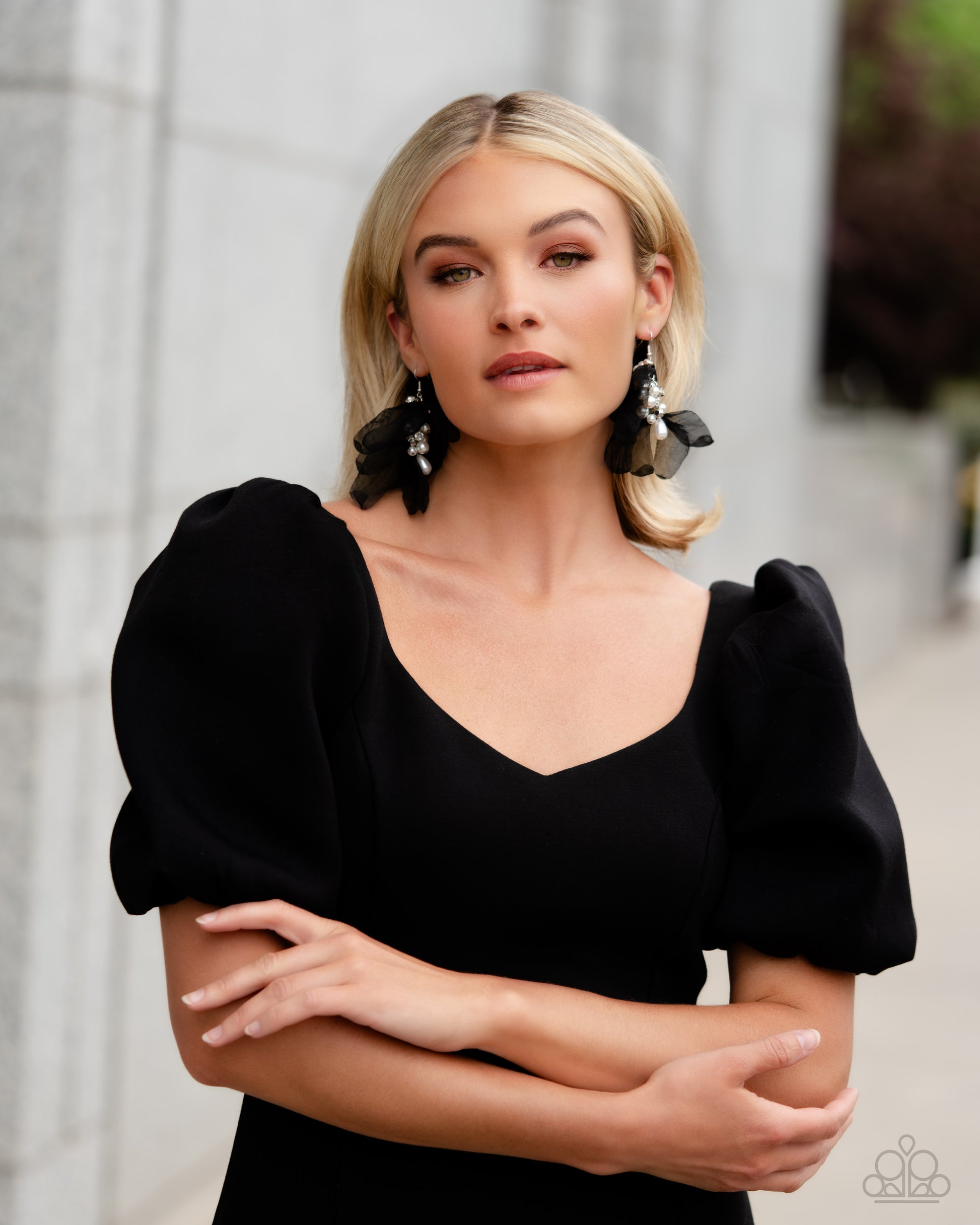 Featuring a layered motif, elongated black silk petals are separated by a sprinkle of white gems in silver fittings that mingle with a cluster of dreamy white pearls, creating a high-society fringe. Earring attaches to a standard fishhook fitting.  Sold as one pair of earrings.