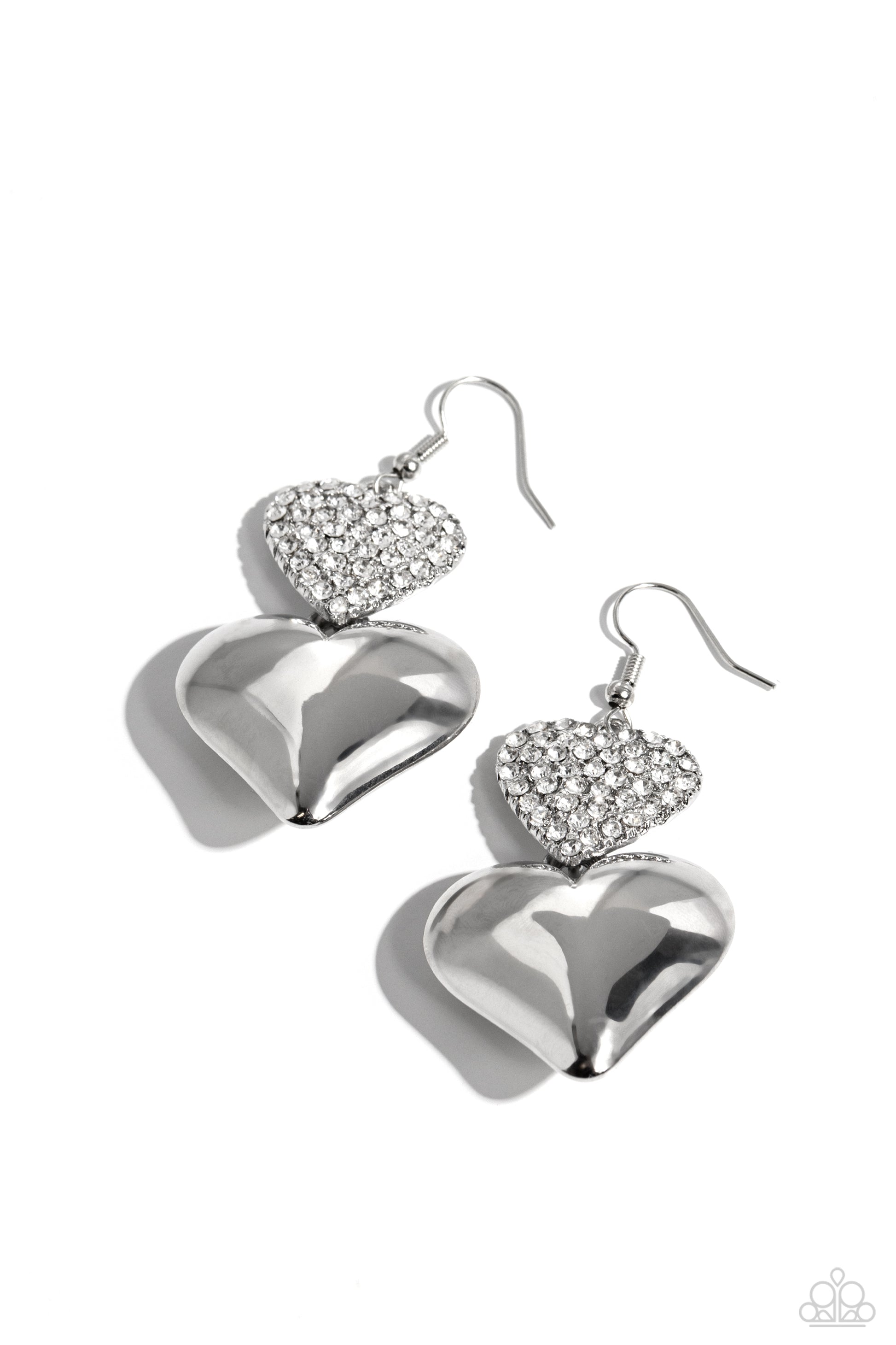 <p>Delicately dusted in white rhinestones, a blinding silver heart frame delicately links with a larger sleek silver heart for a flirtatiously layered look. Earring attaches to a standard fishhook earring.</p> <p><i> Sold as one pair of earrings.</i></p>