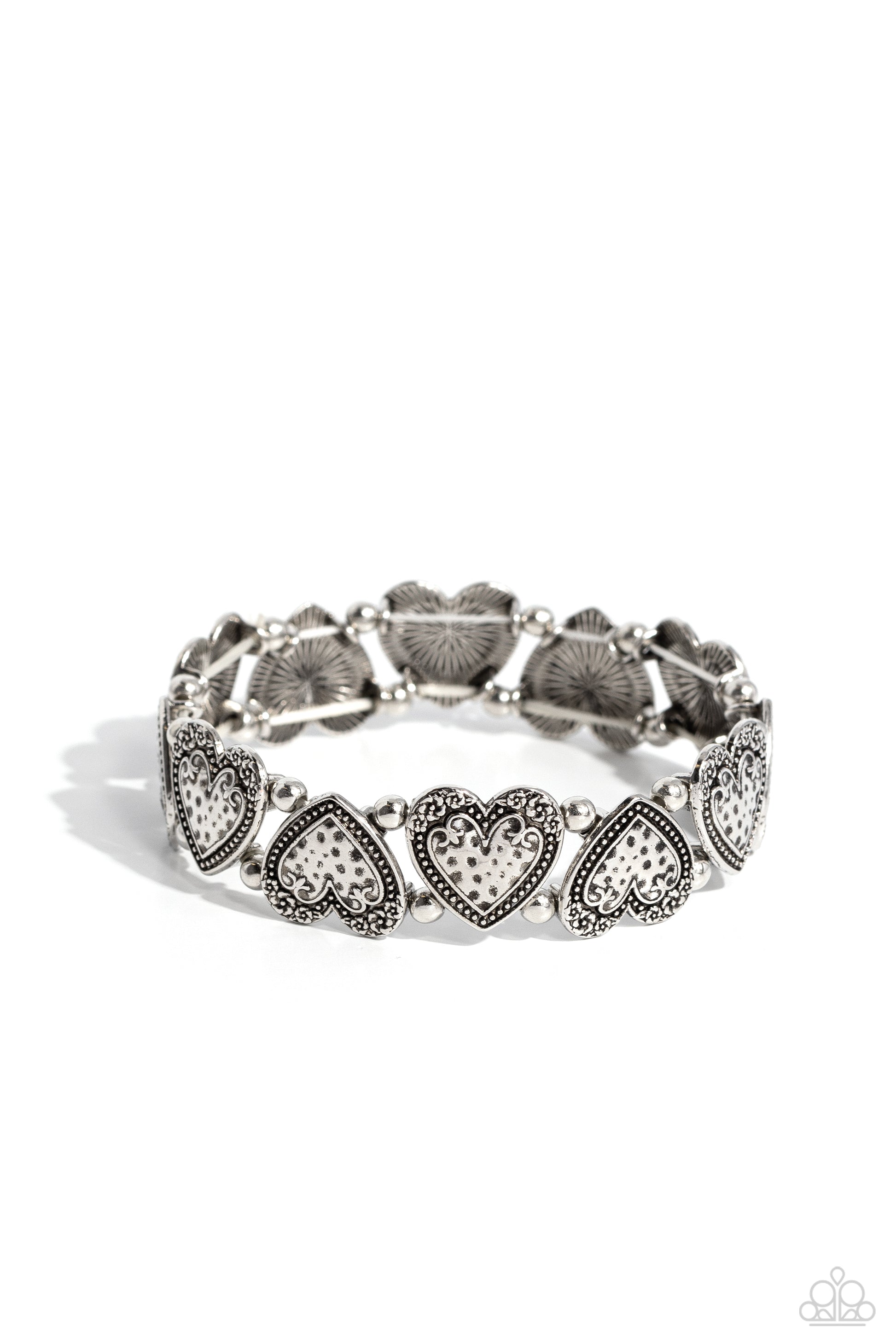 <p>Featuring dainty floral accents, and a hammered, studded surface, a collection of silver hearts, separated by stacked silver beads, alternate in direction around the wrist on elastic stretchy bands to create a dynamic statement.</p> <p><i> Sold as one individual bracelet.</i></p>