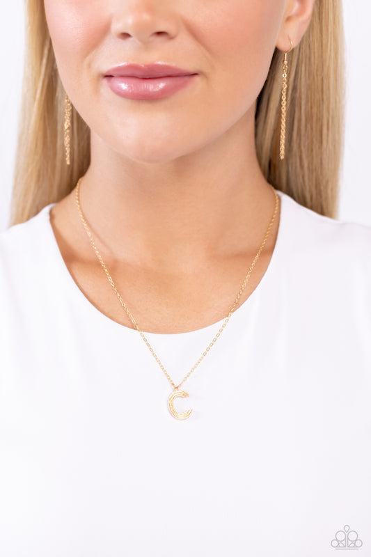 Etched in linear texture, a gold letter "C" hovers below the collar from a dainty gold chain, for a sentimentally simple design. Features an adjustable clasp closure.  Sold as one individual necklace. Includes one pair of matching earrings.