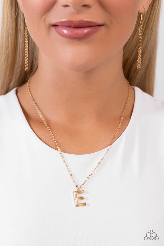 Etched in linear texture, a gold letter "E" hovers below the collar from a dainty gold chain, for a sentimentally simple design. Features an adjustable clasp closure.  Sold as one individual necklace. Includes one pair of matching earrings.