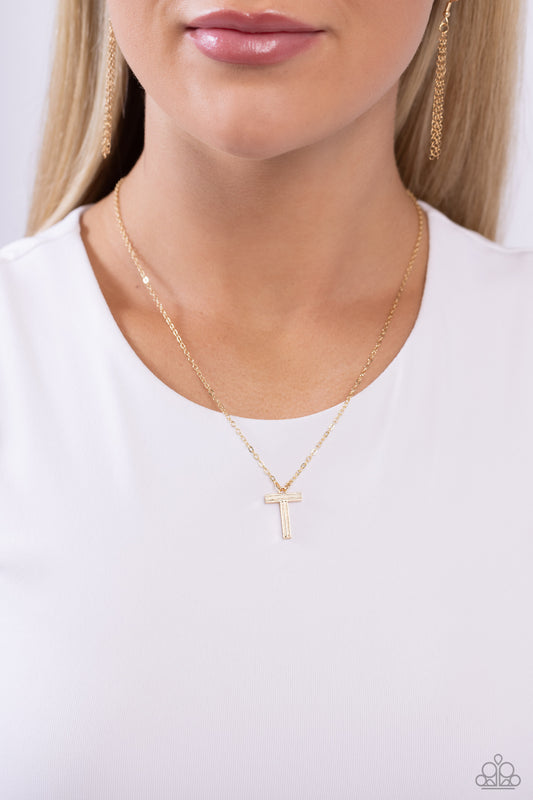 Etched in linear texture, a gold letter "T" hovers below the collar from a dainty gold chain, for a sentimentally simple design. Features an adjustable clasp closure.  Sold as one individual necklace. Includes one pair of matching earrings.