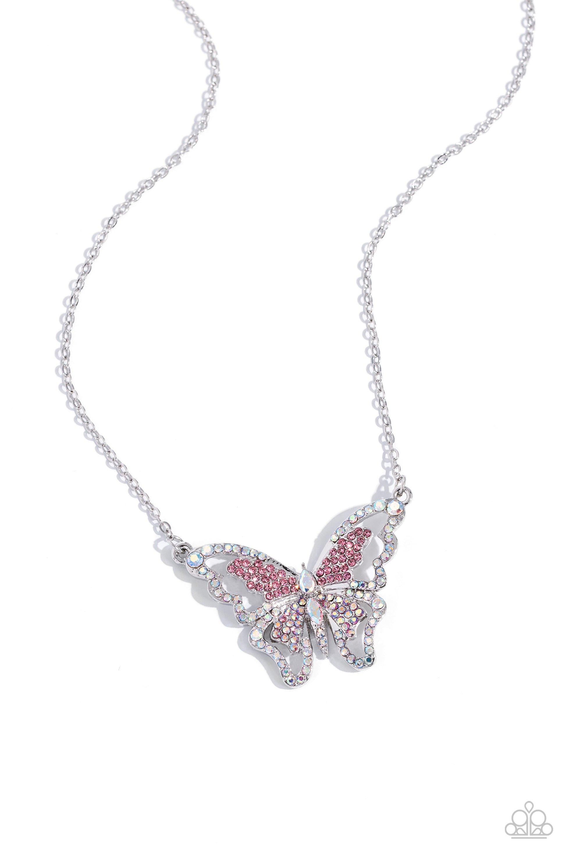 <p>Bordered in glassy iridescent rhinestones, an airy, oversized silver butterfly is dotted in dainty iridescent and pink rhinestones in various cuts as it flutters from a silver chain below the collar for an enchanting fashion. Features an adjustable clasp closure. Due to its prismatic palette, color may vary.</p> <p><i> Sold as one individual necklace. Includes one pair of matching earrings.</i></p>