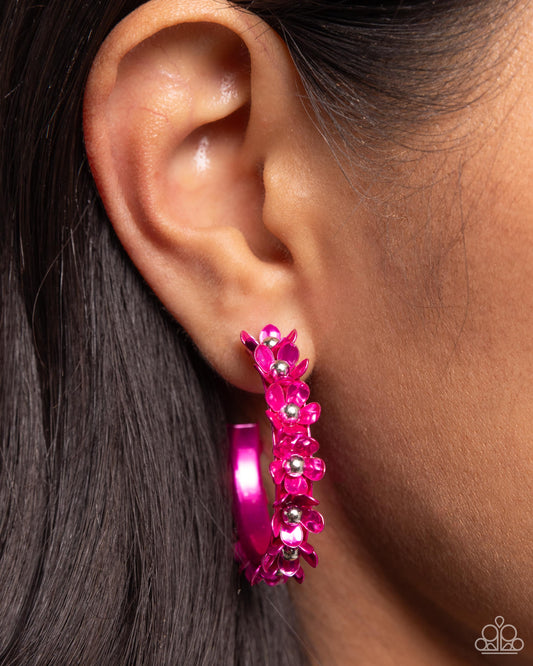 <p>Dipped in a hot pink hue, a hollowed-out hoop curls around the ear. Featuring silver beaded centers, metallic hot pink flowers bloom along the curl of the hollow of the hoop for a fashionable display. Earring attaches to a standard post fitting. Hoop measures approximately 1 1/4" in diameter.</p> <p><i> Sold as one pair of hoop earrings.</i></p>