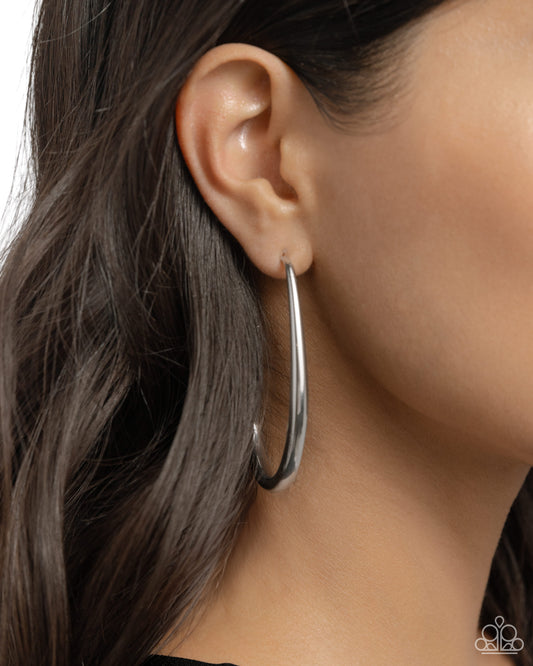 <p>Featuring a reflective sheen, a strand of sleek silver loops in an abstract teardrop frame for an exclusive look. Earring attaches to a standard post fitting. Hoop measures approximately 1 1/2" in diameter.</p> <p><i> Sold as one pair of hoop earrings.</i></p>