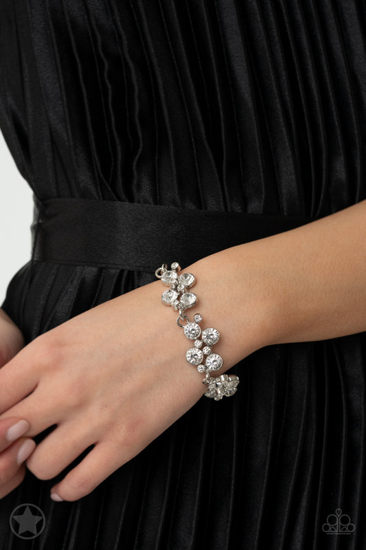 Clusters of brilliant white rhinestones drape elegantly along the wrist. The scattered pattern and varying sizes of the rhinestones add breathtaking detail to the piece. Features an adjustable clasp closure.  Sold as one individual bracelet.   Get The Complete Look! Necklace: "Hollywood Hills" (Sold Separately)