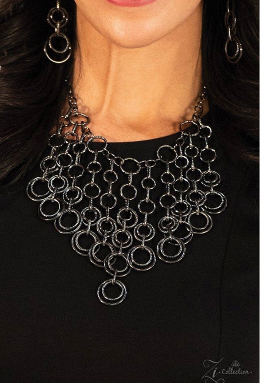 A collection of glistening gunmetal hoops connects to form dramatic tassels, falling together into a sassy industrial fringe. The centermost tassel is slightly elongated, creating a fierce focal point as the web of gunmetal rings lays delicately across the chest. Features an adjustable clasp closure.